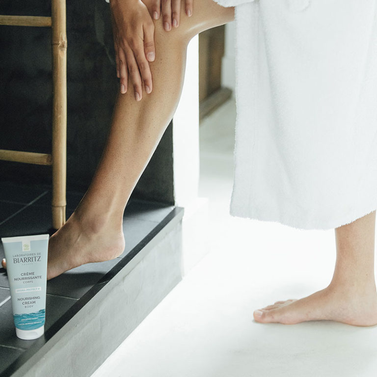 application de crème hydratante sur les jambes